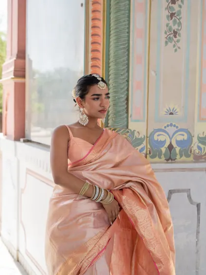 We are in our silk saree Banaras mood. This baby pink silk saree is a classic and elegant choice.