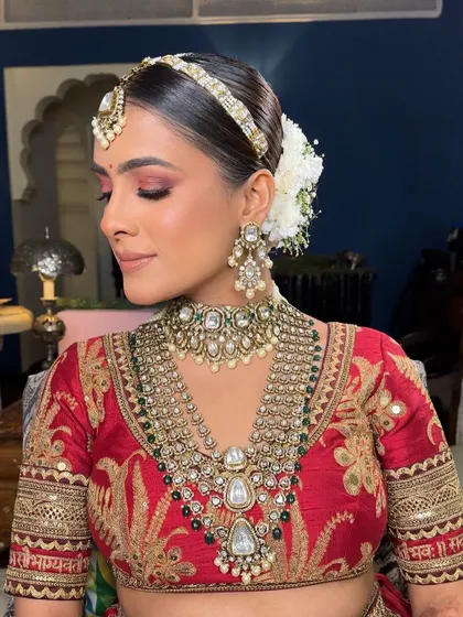 A side profile of the Sabyasachi bride, her classic gajra bun and traditional matha patti creating a look of timeless royal elegance.