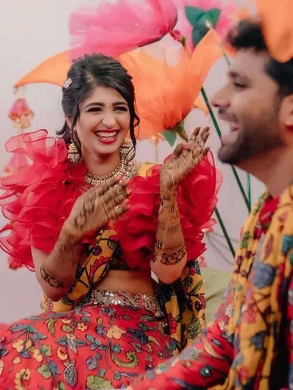 The bride's laughter is the best feedback. Here she is, enjoying her Mehendi ceremony against a backdrop of giant, colourful paper flowers I created for a fun and whimsical touch.