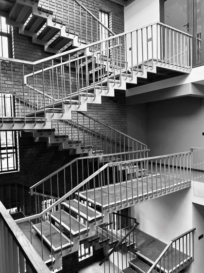 Work-in-progress photos from another residence in Thrissur, showing the raw beauty of the structure with its curved brick walls and complex interior staircases.