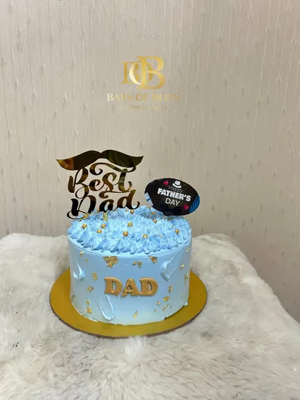 A light blue "Best Dad" cake with a mustache topper, perfect for showing your appreciation on Father's Day.