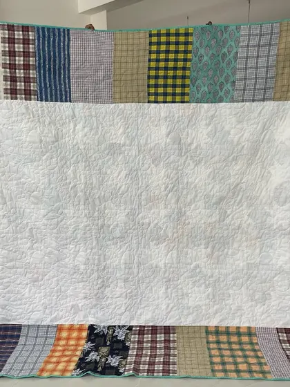 The back of the Sawtooth Star shirt quilt, cleverly constructed from the remaining large pieces of the shirts.