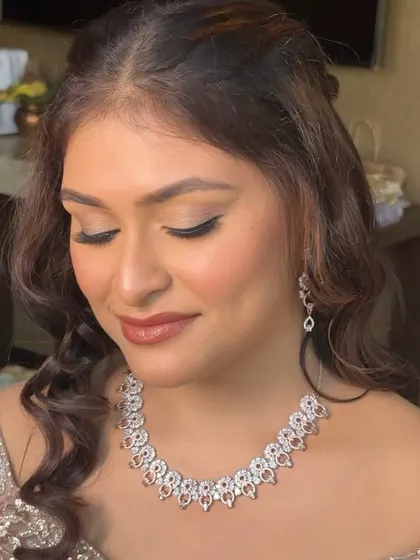 The bride with her eyes closed, showing the beautiful blending of her Sangeet eye makeup. It's elegant and sophisticated.