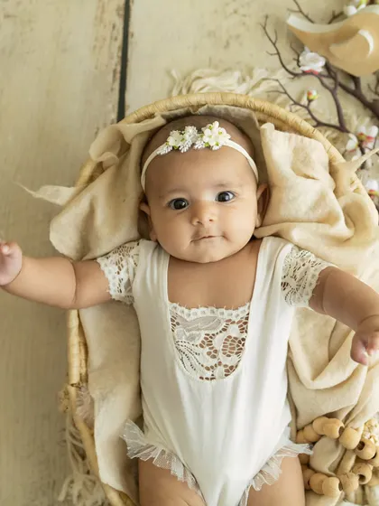 A beautiful, direct gaze. This baby's big, expressive eyes are the centerpiece of this simple and elegant portrait.