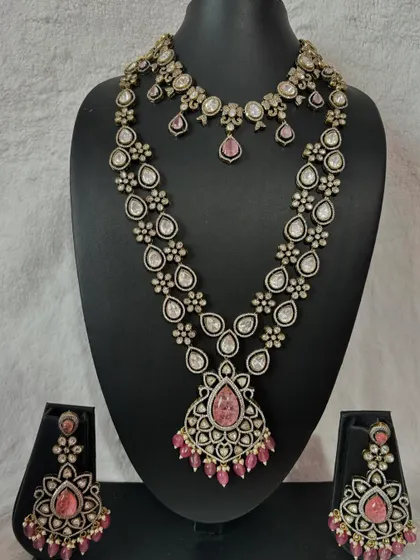 This is a stunning Victorian and Polki combination set with pink stones, perfect for a bride who wants a unique and romantic look for her reception.