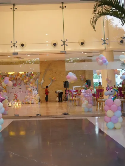 A wide view of the Unicorn party venue, showing the entrance decor and the main stage, creating an immersive experience for guests from the moment they arrive.