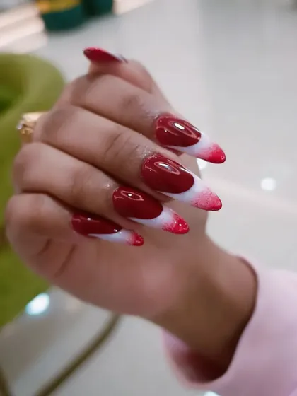 A side view showcasing the pointed stiletto shape and the bold color transition.