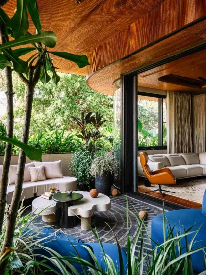 We believe in blurring the boundary between the interior and the exterior. In this Bengaluru residence, the living space flows seamlessly onto a lush terrace, borrowing the surrounding trees into the home's narrative and fostering a deep connection with nature.