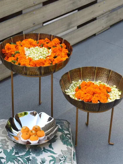 Transform your home into a welcoming space with our stunning Urli decor. This image shows our standing urlis and a floral bowl filled with marigolds, perfect for Navratri or any festival.