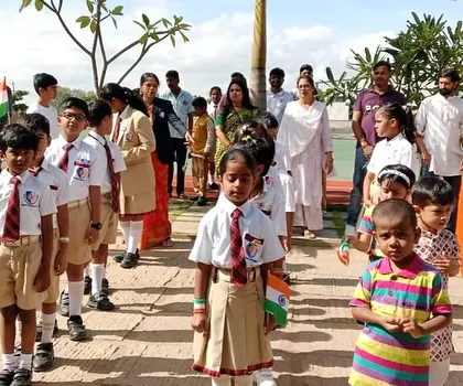 Students and teachers stand with pride during the Independence Day assembly, listening to speeches and singing patriotic songs.