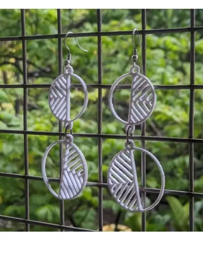 A pair of stylish, geometric earrings designed and 3D printed by a workshop participant.