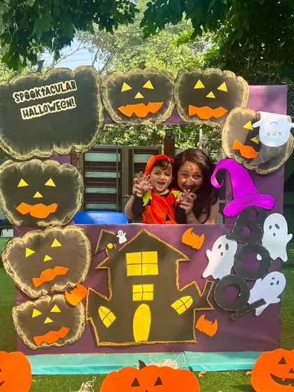 A spooky and fun photo opportunity at our Halloween Workshop. A mother and child enjoy the themed photo booth, creating fun memories together.