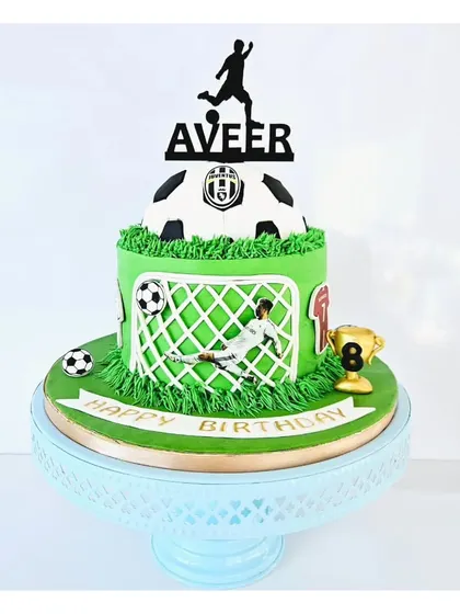 Score a goal with the birthday boy! This football-themed cake features a green field, a goalie in action, and a personalized topper. It's a fantastic choice for any young soccer fan's celebration.