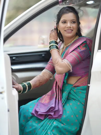 The bride arriving in style. Her makeup is picture-perfect, ensuring she looks stunning from the moment she steps out of the car.