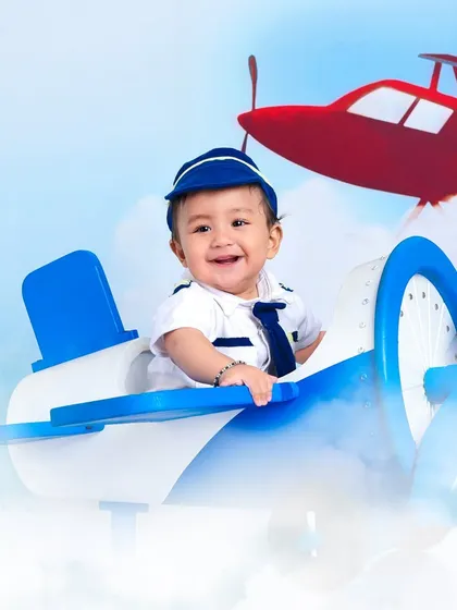 Soaring through the clouds. This shot gives the illusion of flight, making for a dynamic and exciting portrait of our little aviator.