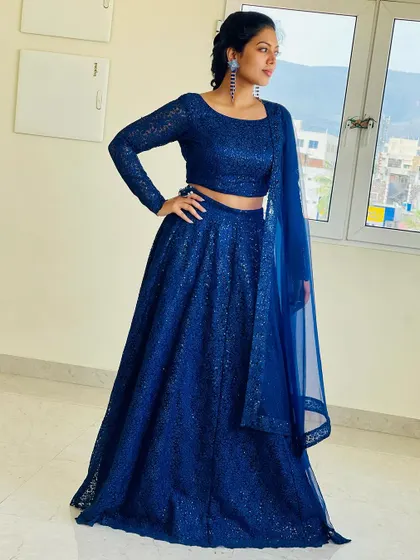 A full-length shot of the elegant royal blue sequin lehenga, perfect for a reception or sangeet.
