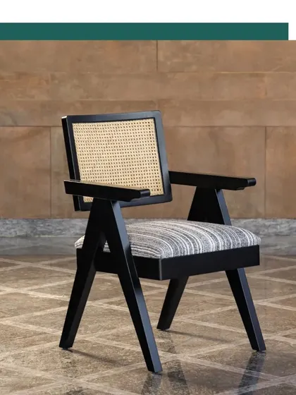 A side profile of our Chandigarh Chair, showcasing its strong, angular lines and the expert craftsmanship that goes into each piece.