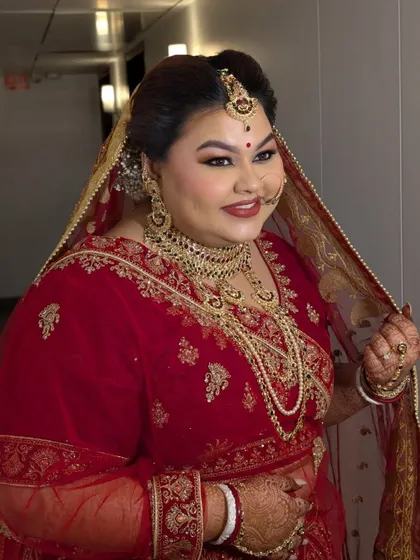 A candid moment showing the bride adjusting her dupatta, looking absolutely regal.