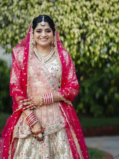 This bride is glowing. The makeup enhances her features beautifully, and the hairstyle is both traditional and elegant.