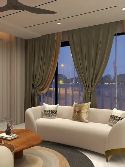 A different angle of the Hemkunt drawing room, highlighting the balance between the bold orange sofa and the elegant cream-colored couch, framed by floor-to-ceiling curtains.