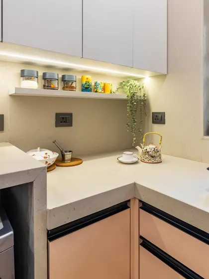 A small floating shelf provides the perfect spot for frequently used spices and mugs, keeping the countertop clear and organized.