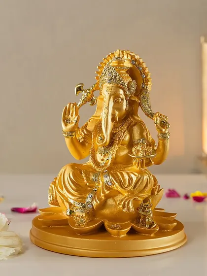 This radiant golden sculpture of Lord Ganesh is a symbol of new beginnings and wisdom. The detailed craftsmanship makes it a powerful and auspicious showpiece for your home or office.