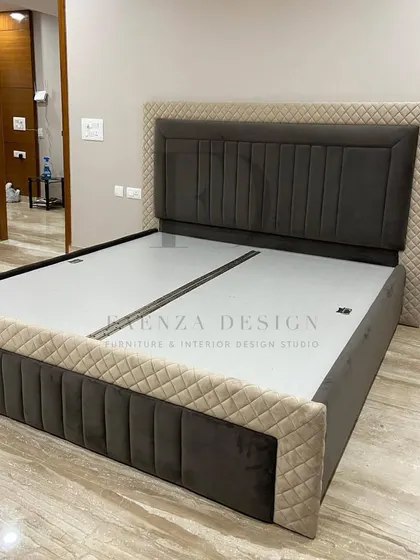This custom bed features a dual-textured headboard, combining a smooth dark grey central panel with a quilted beige outer frame. The design is modern, unique, and tailored to our client's taste.