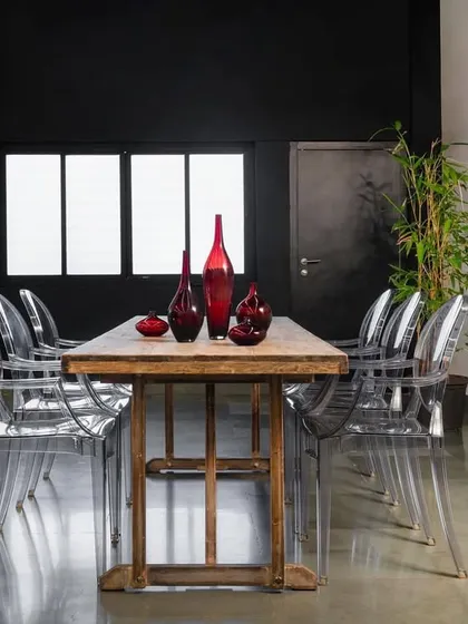 For this 1,200 sq. ft. fashion showroom in Mumbai, we created a dance of contrasts where industrial meets elegance. A rustic wooden table is paired with modern transparent chairs against a bold, black wall, telling a story of versatile design.