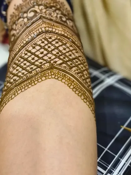 Another angle of the geometric armband, showing the henna cone tip to give a sense of scale to the fine lines.