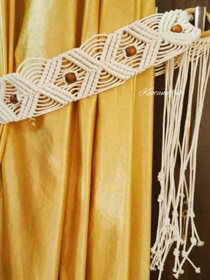 Add a touch of elegance to your home with these intricately knotted macrame curtain tiebacks. They are perfect for any decor style.