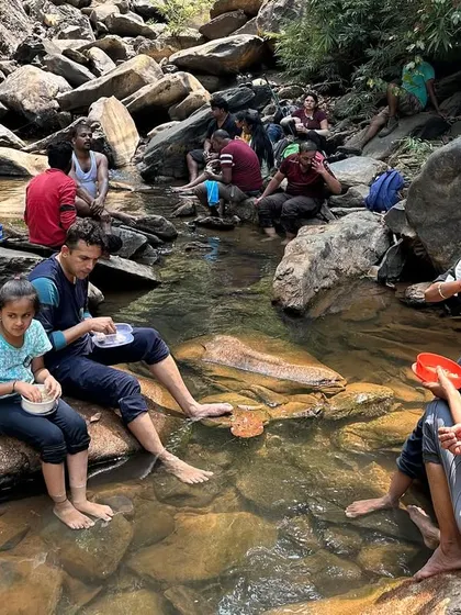 Enjoying a meal by the stream. Everything tastes better in the lap of nature.