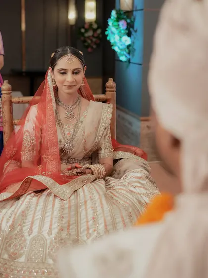 The bride's serene expression as she watches the ceremony, seen from the groom's perspective.