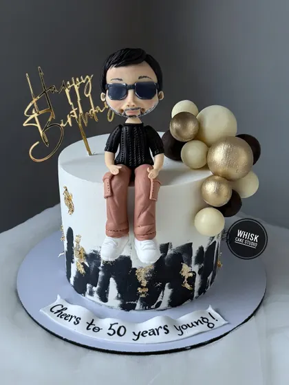 A cake for a milestone 50th birthday. This design features a cool, handcrafted figurine modeled on the birthday boy, complete with sunglasses and a stylish outfit.