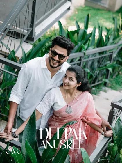 A stylish couple portrait on a staircase surrounded by lush greenery, with their names elegantly overlaid.