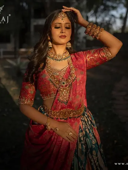 A close-up of the model in the multi-colored banarasi lehenga, showcasing the intricate jewelry and beautiful craftsmanship of the outfit.