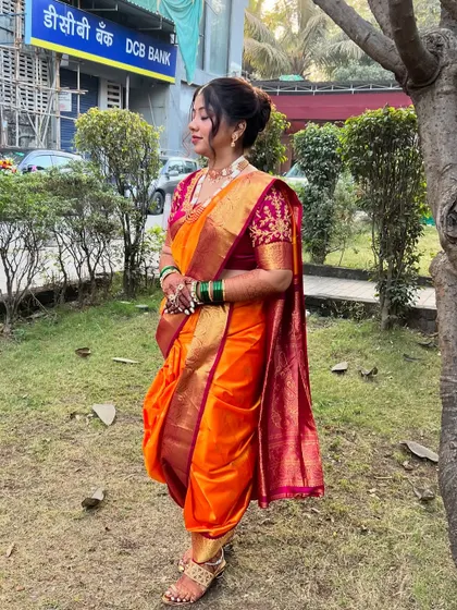 A full-length view of the perfectly draped nauvari saree, showcasing its timeless elegance.