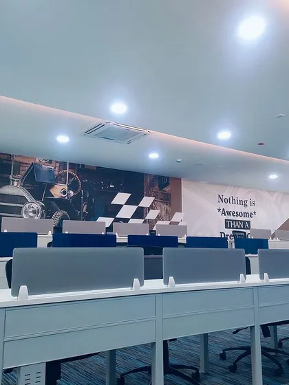 This perspective shows the scale of the seating arrangement and the clean, modern aesthetic of the auction space. Desk dividers provide a degree of privacy for bidders.