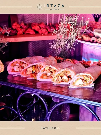 Hearty and flavorful Kathi Rolls, sliced and ready to be served. These are a fantastic, filling option for a more casual event or as part of a larger street food-themed station.