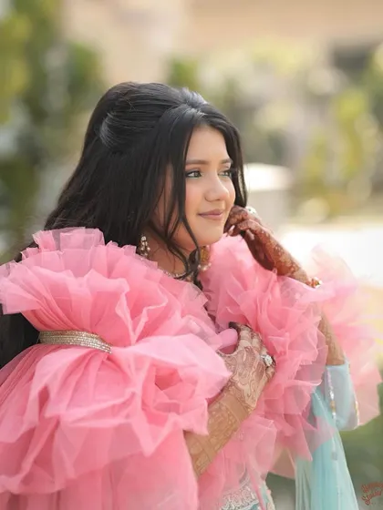 The final look is a doll-like, pretty style with a high puff and soft waves. This hairstyle is perfect for a fun, daytime event and looks great with her ruffled dupatta.