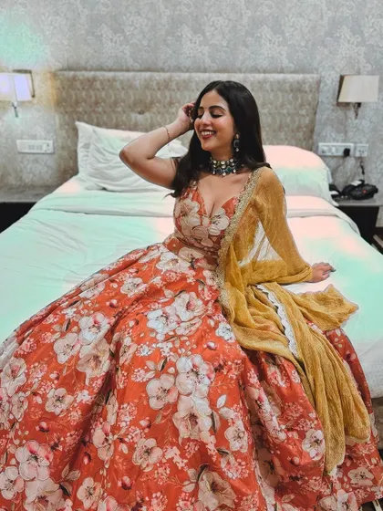 A happy and relaxed shot of the client in her floral lehenga.