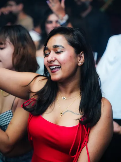 A happy face in the crowd, enjoying the old school hip hop and R&B vibes.
