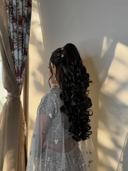 Another view of the voluminous ponytail, showing how it adds a touch of modern glamour to the look.