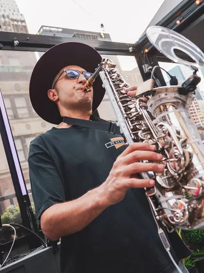Fusing my DJ set with a live saxophonist at a New York City sundowner. I love collaborating with live musicians to add a unique, soulful layer to the party's energy.