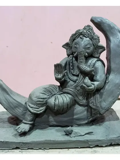 This 'Bappa on the Moon' is a popular custom design. The entire piece, from the base to the tip of the moon, is sculpted by hand, making it a special, one-of-a-kind handmade idol for your home.