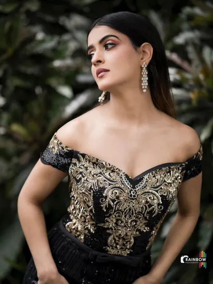 This image demonstrates my work with modern, high-fashion looks. The off-shoulder gown with intricate gold embroidery is the star, and I used natural, diffused lighting against a dark green backdrop to make the details pop and create a moody, elegant portrait.