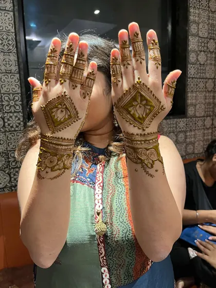 A happy client showing off her matching lotus designs. This is a great choice for bridesmaids or guests.