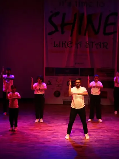 An instructor leading a large group of students in a synchronized routine.