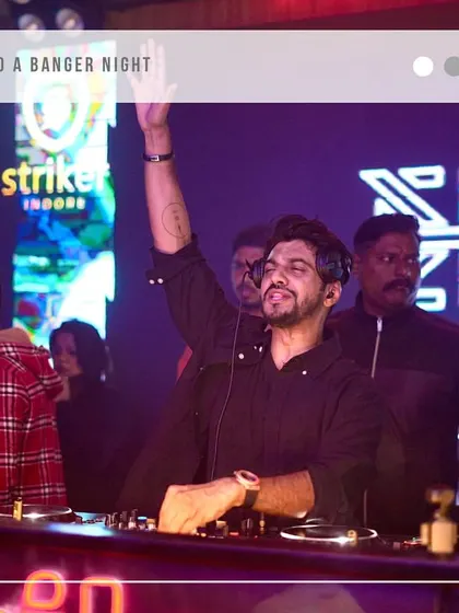 A graphic overlay celebrating a banger night at Striker, Indore. This shot captures me raising a hand to the crowd, connecting with their energy.