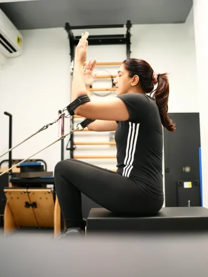 A client finds strength in stillness and power in every breath. This exercise on the reformer connects mind, body, and breath with every controlled move.