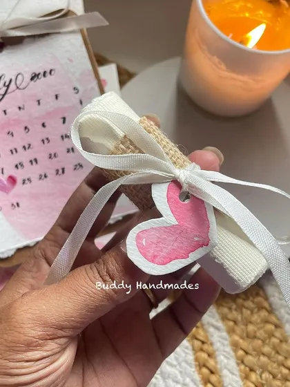 A tiny rolled-up message with a heart tag, part of a larger birthday gift set. It's the little details that count.